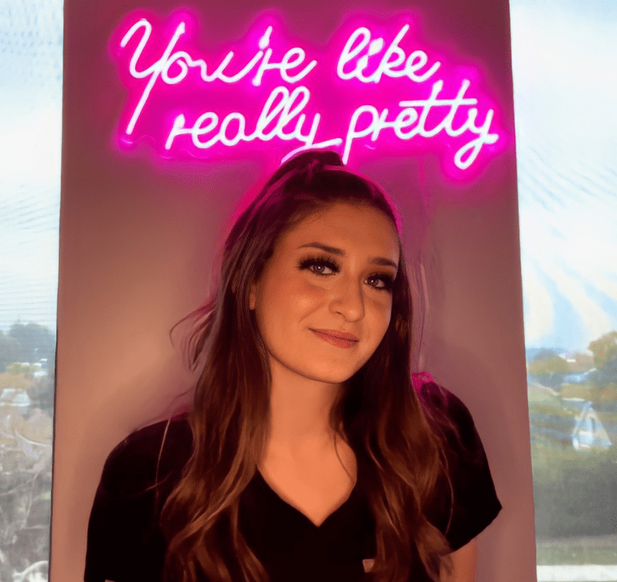 woman in front of neon sign